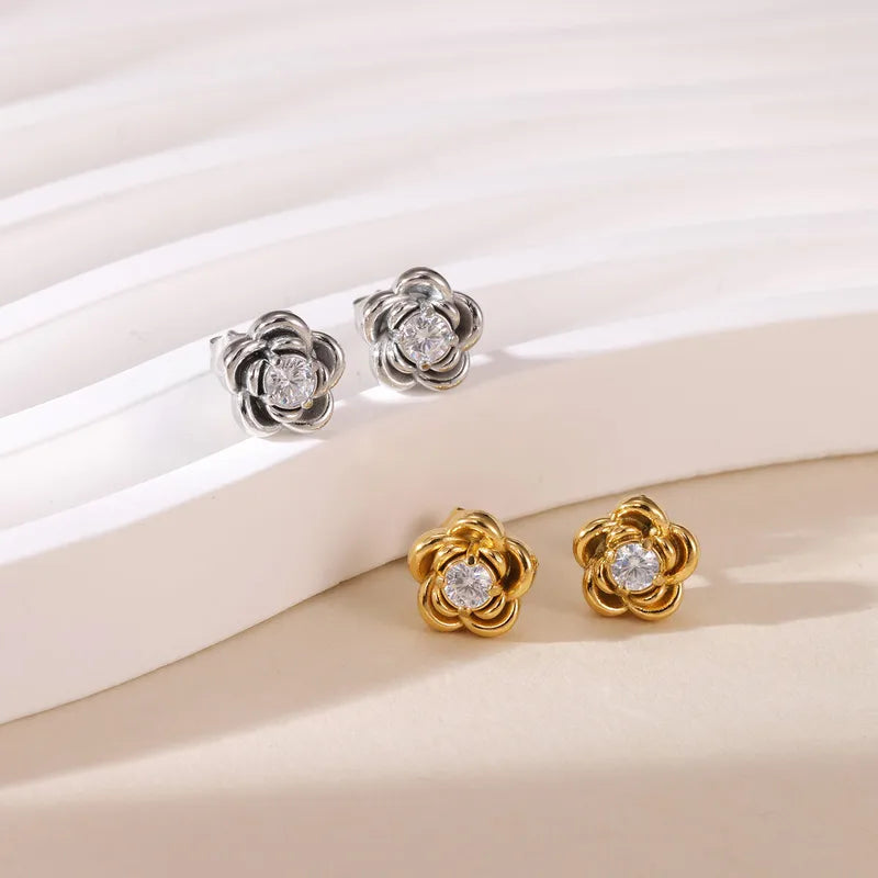 HiranyaVarna Bloom Stud Earrings in 18K Gold PVD — close-up of flower stud with cubic zirconia centre on white background